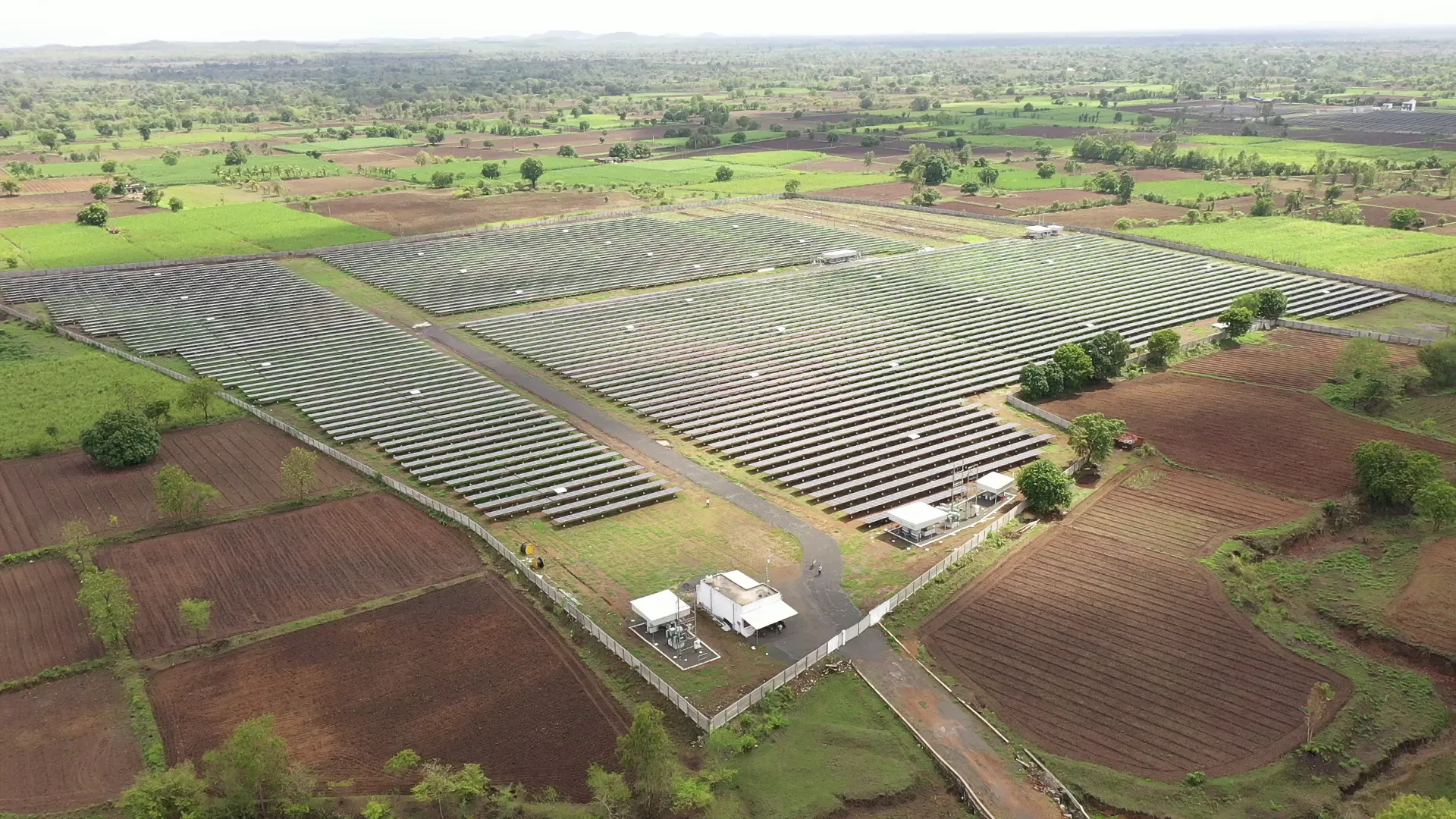 Large-scale solar installation at Rayzon Solar Park 5 in Umalla surrounded by farmland.